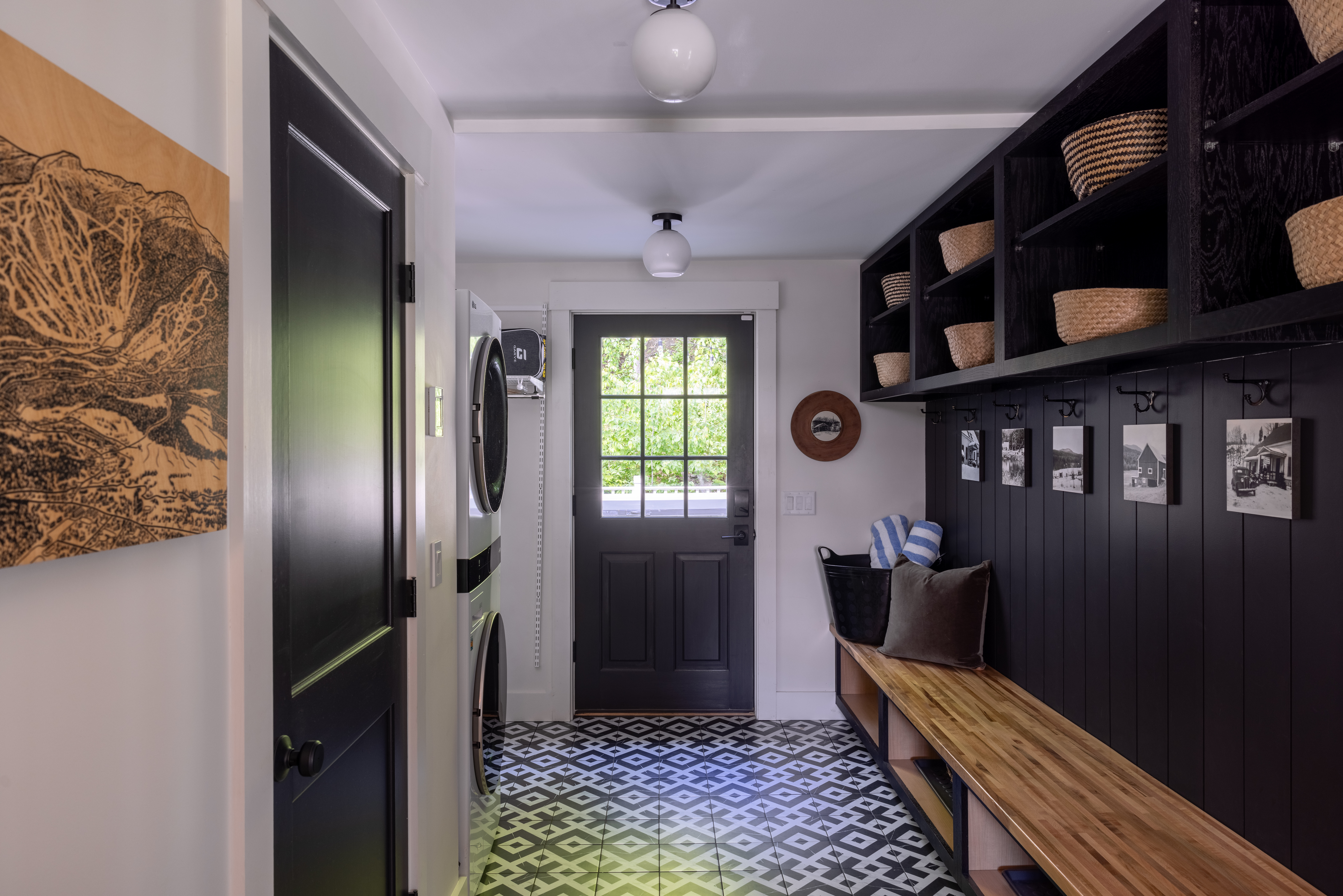 Mudroom hallway with built-in bench, storage, and patterned tile floor